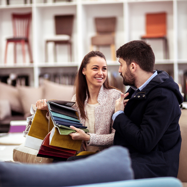 Couple at a furniture store choosing fabrics